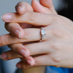 A model wearing a gorgeous three stone asscher cut lab grown diamond ring on her finger.