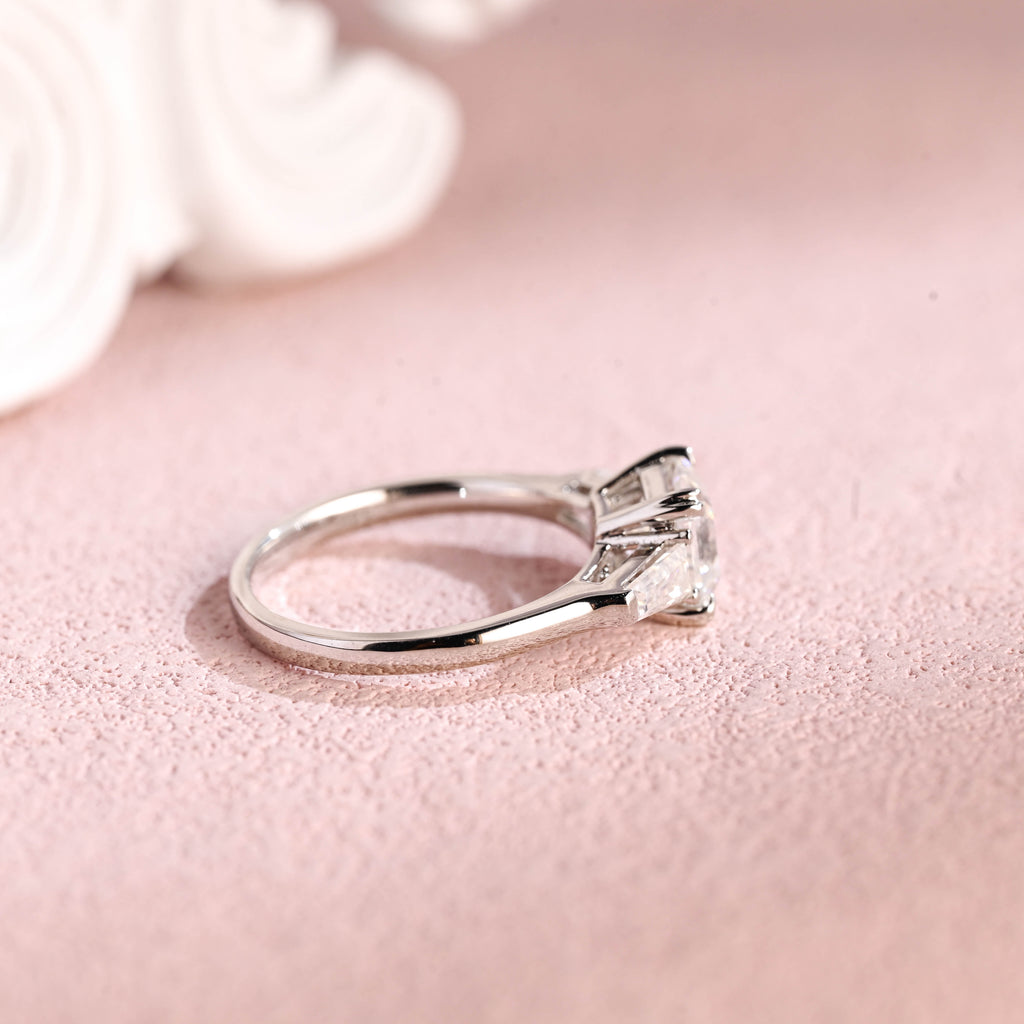 Side profile of a modern asscher cut lab diamond engagement ring with side stones.
