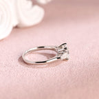 Side profile of a modern asscher cut lab diamond engagement ring with side stones.
