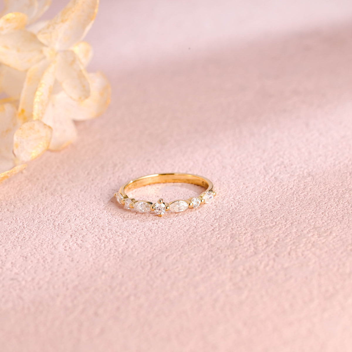 A dainty 14k yellow gold cluster ring featuring 4 marquise and 3 round lab grown diamonds totaling 0.4 ctw.