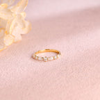 A dainty 14k yellow gold cluster ring featuring 4 marquise and 3 round lab grown diamonds totaling 0.4 ctw.