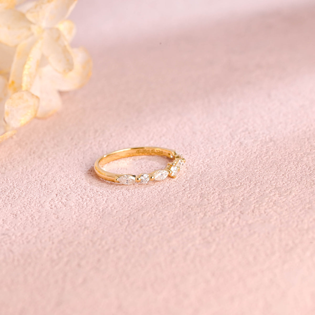 A dainty 14k yellow gold cluster ring featuring 4 marquise and 3 round lab grown diamonds totaling 0.4 ctw.