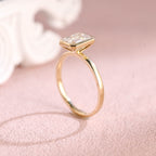 Close up angle shot highlighting the clean step-cut facets of an emerald lab diamond ring.