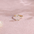 A luxurious emerald cut lab grown diamond engagement ring with micro-pave accent stones on the band and a d color vs1 center stone in white gold.