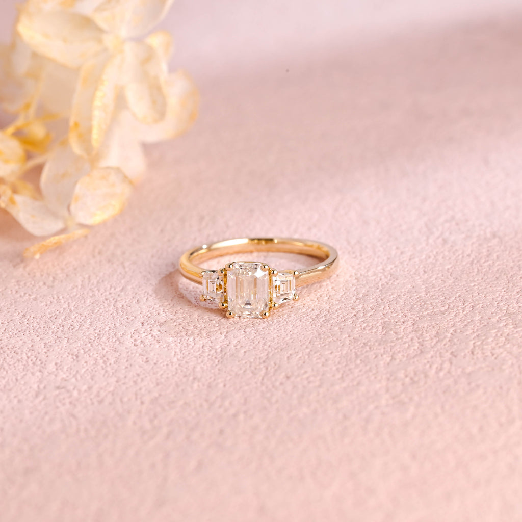 Side profile and macro view of an emerald cut lab created diamond ring showing the 4 prong basket setting and high polish solid white gold band.