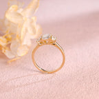 Side profile and macro view of an emerald cut lab created diamond ring showing the 4 prong basket setting and high polish solid white gold band.