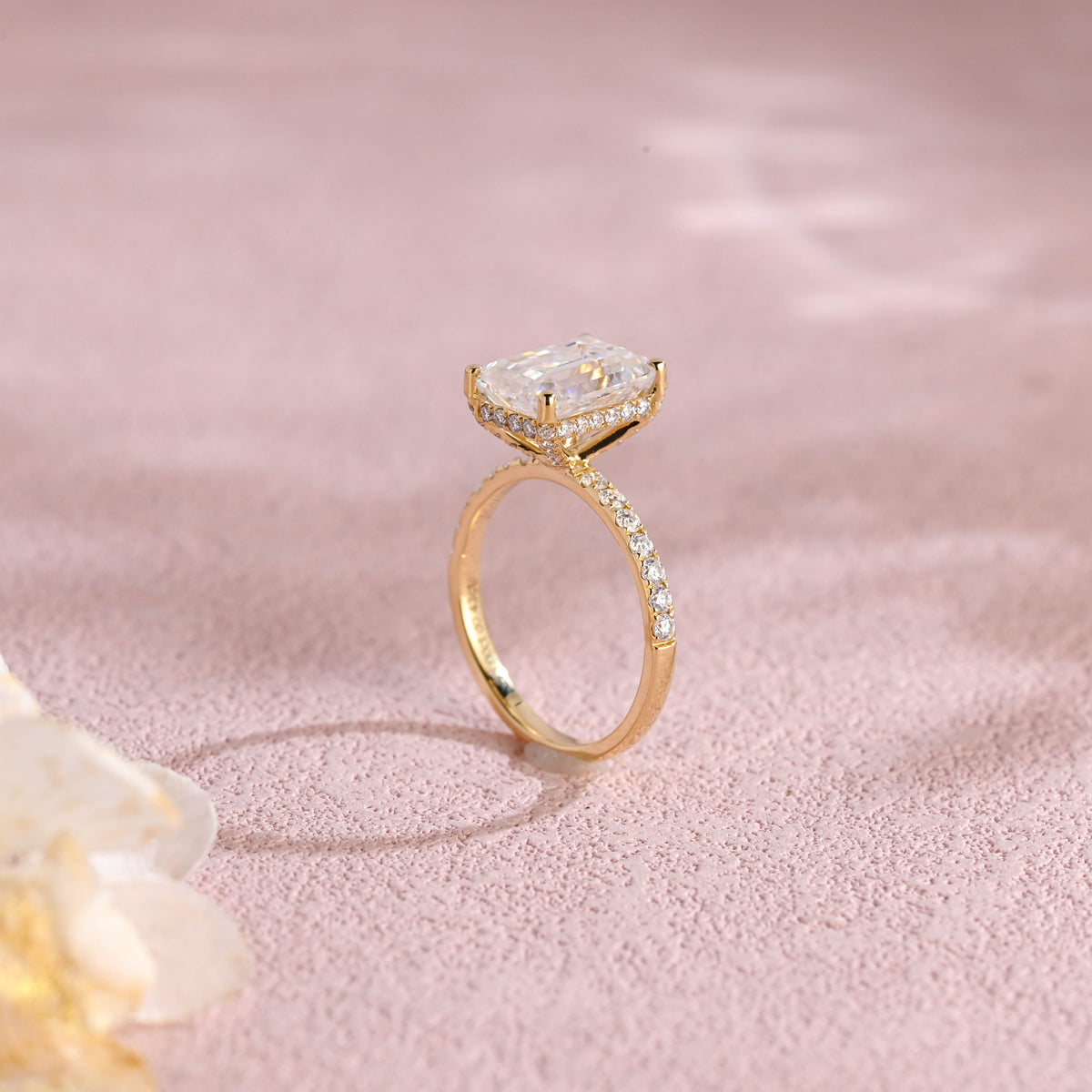 Side profile macro view of an emerald cut lab created diamond ring showing the intricate micro-pave basket and accent stones.