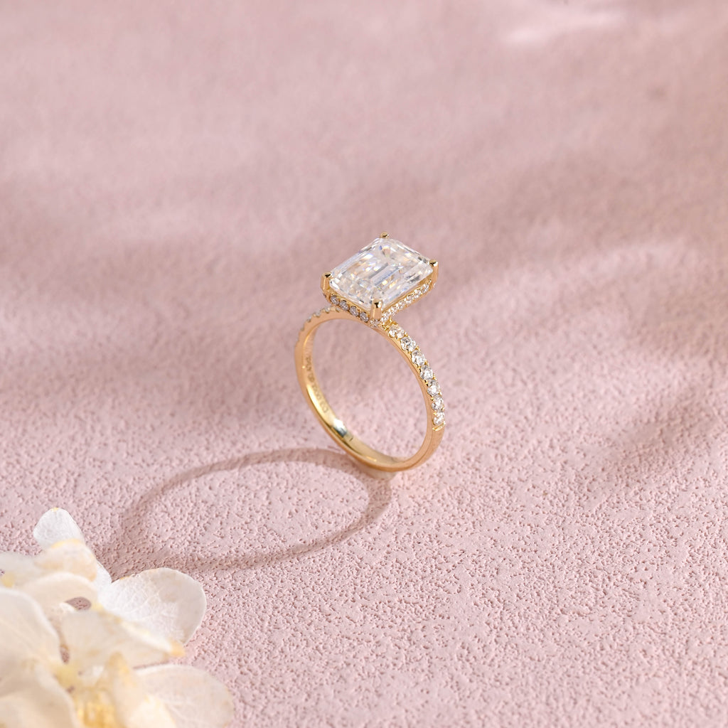 Side profile macro view of an emerald cut lab created diamond ring showing the intricate micro-pave basket and accent stones.