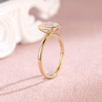 Close up angle shot highlighting the clean step-cut facets of an emerald lab diamond ring.
