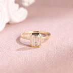 Front view of an IGI certified emerald cut lab grown diamond ring in a bezel setting on pink background.
