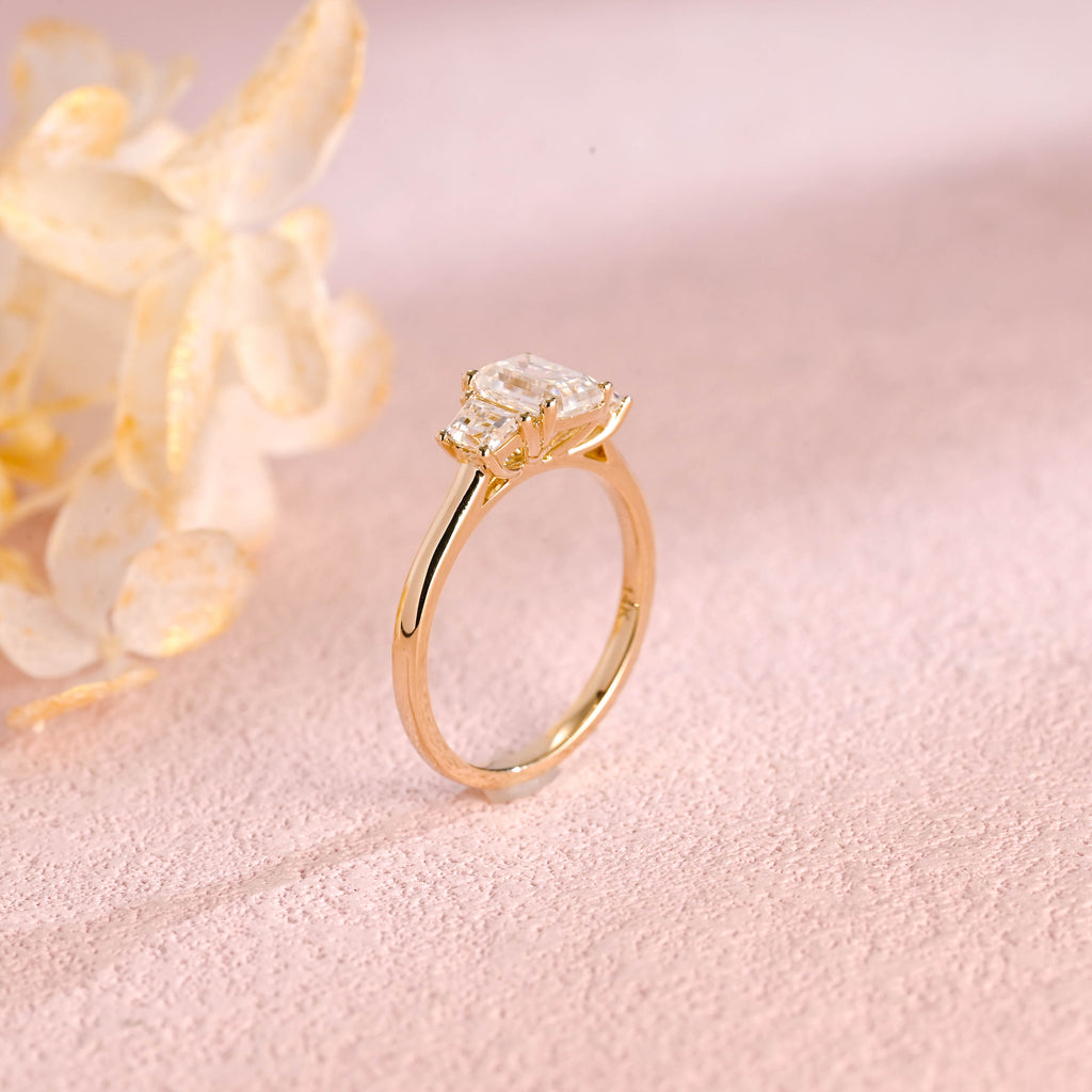 Side profile and macro view of an emerald cut lab created diamond ring showing the 4 prong basket setting and high polish solid white gold band.