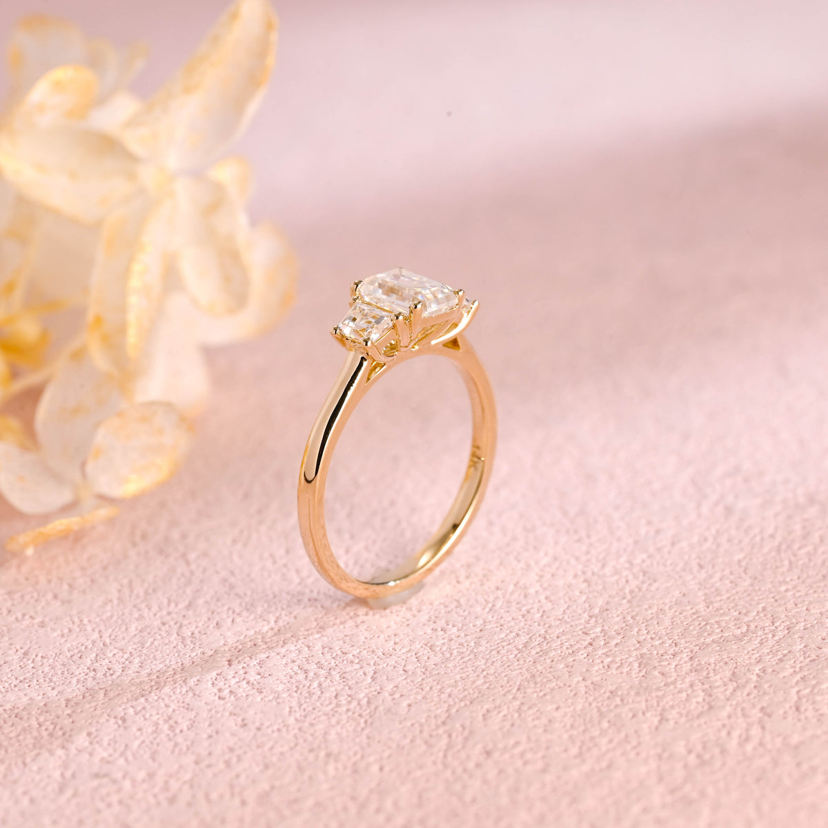 Side profile and macro view of an emerald cut lab created diamond ring showing the 4 prong basket setting and high polish solid white gold band.