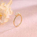 Side profile and macro view of an emerald cut lab created diamond ring showing the 4 prong basket setting and high polish solid white gold band.