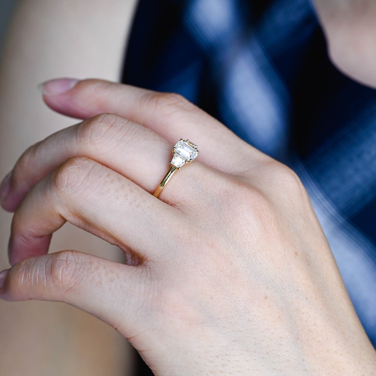 Premium ethical emerald cut lab grown diamond 3 stone ring showcased inside a luxury gift box with official IGI certification papers.