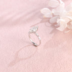 A 14k yellow gold marquise cut lab grown diamond engagement ring with 4 round accent stones on the band and white gold prongs.
