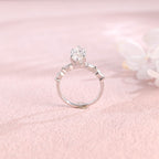A 14k yellow gold marquise cut lab grown diamond engagement ring with 4 round accent stones on the band and white gold prongs.