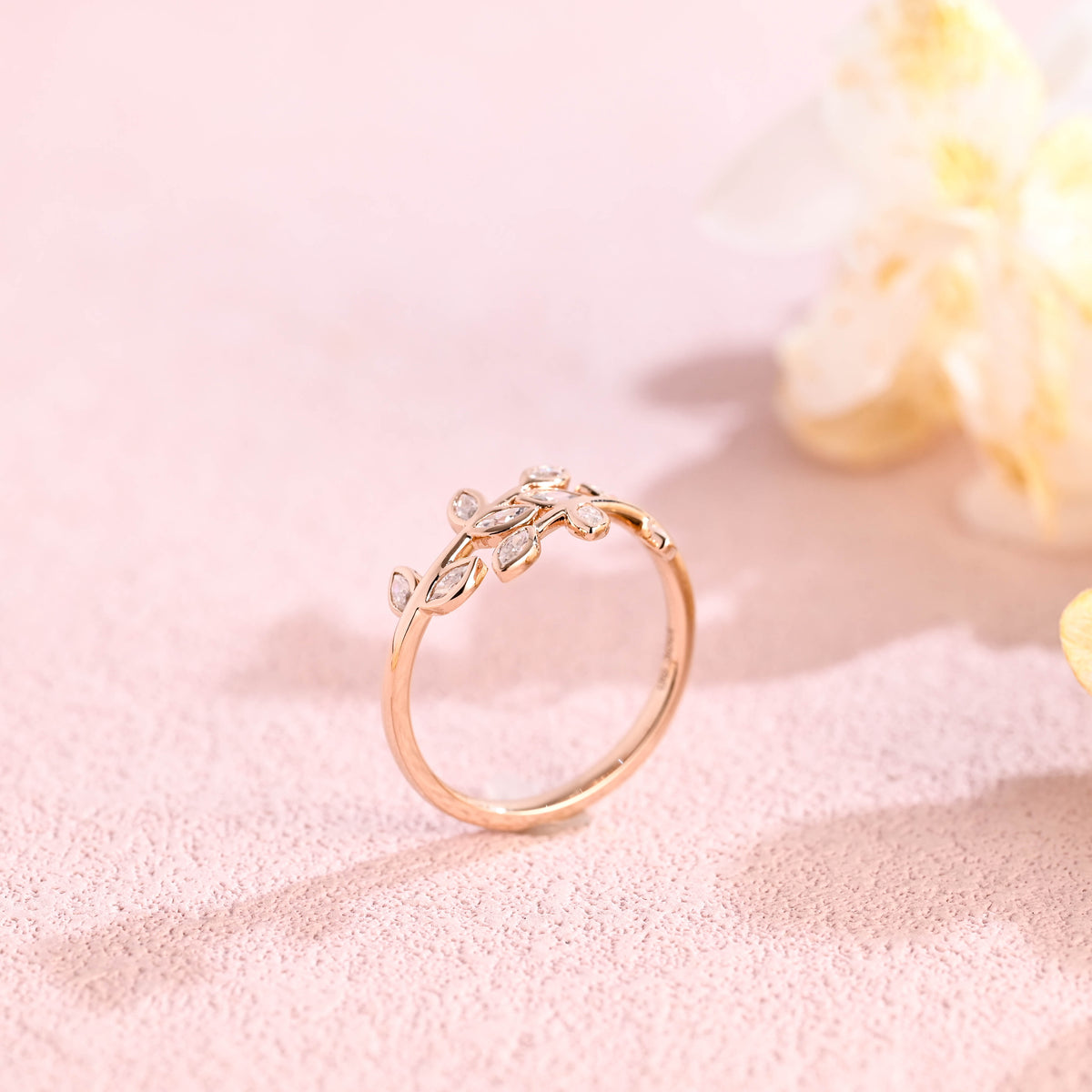 Side profile macro view of a marquise shaped lab created diamond cluster ring showing secure V-prongs and band structure.