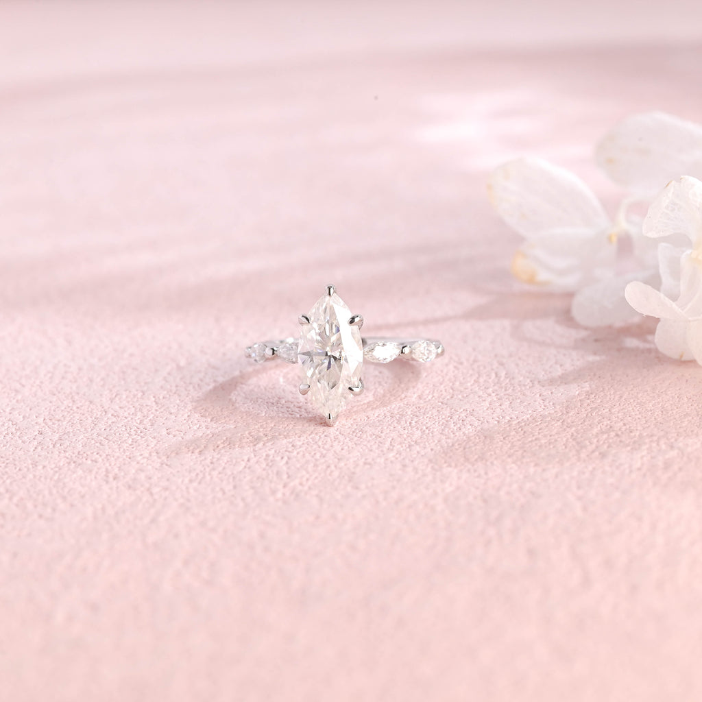 Side profile view of a marquise cut lab created diamond ring showing the hidden halo basket setting and 4 accent stones.