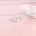 Side profile view of a marquise cut lab created diamond ring showing the hidden halo basket setting and 4 accent stones.