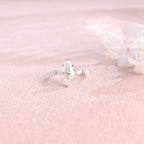 Side profile view of a marquise cut lab created diamond ring showing the hidden halo basket setting and 4 accent stones.