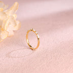 Side profile view of a cluster lab created diamond ring showing individual V-prongs and solid metal band.