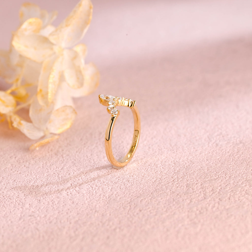 Side profile view of a marquise and round lab created diamond cluster stacking ring showing individual prong settings in white and rose gold.