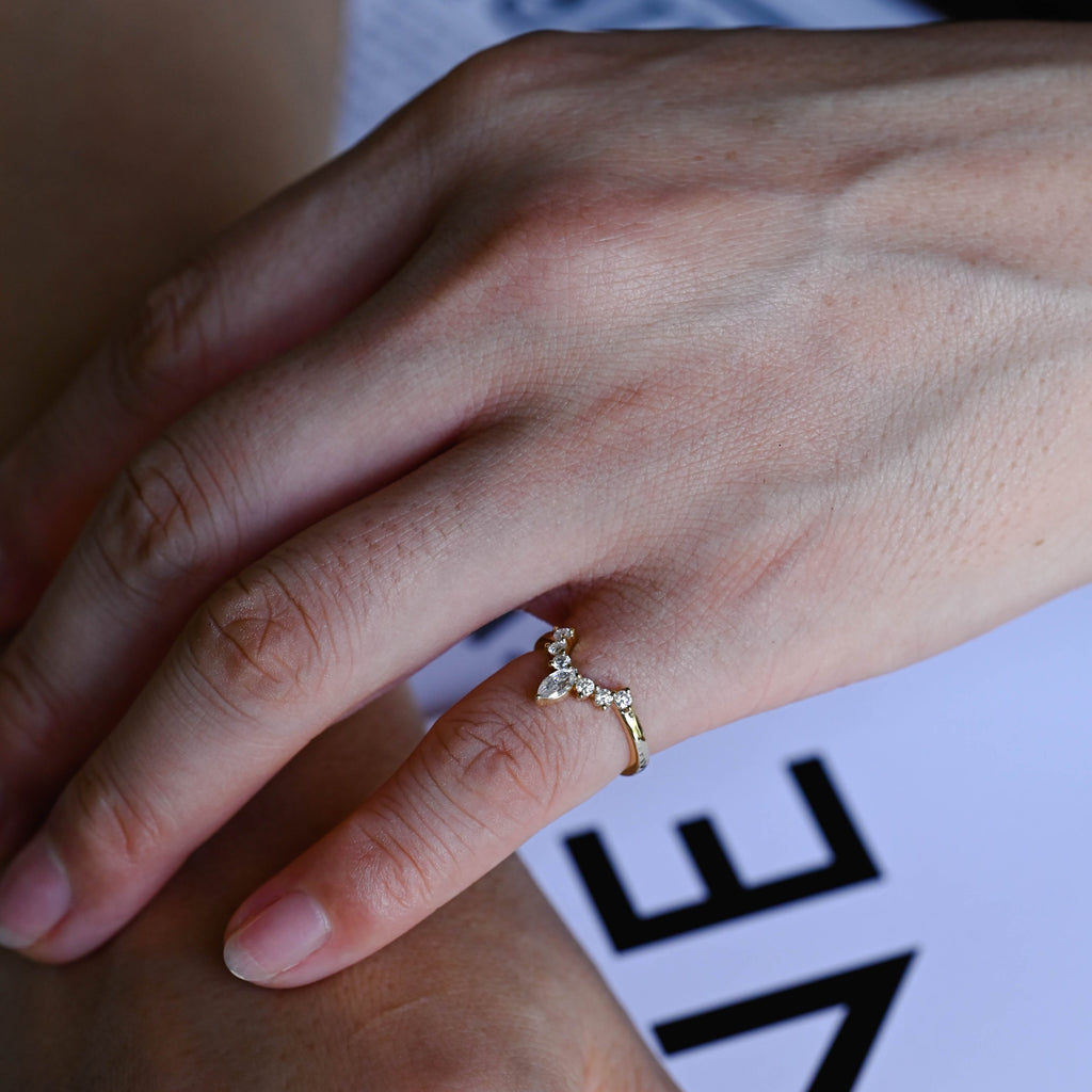 Dainty marquise and round lab grown diamond wedding band showcased inside a luxury gift box.
