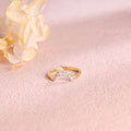 A dainty 14k yellow gold alternating marquise and round lab grown diamond band 0.3 ctw on a neutral background.