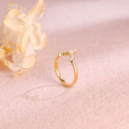 A dainty 14k yellow gold alternating marquise and round lab grown diamond band 0.3 ctw on a neutral background.