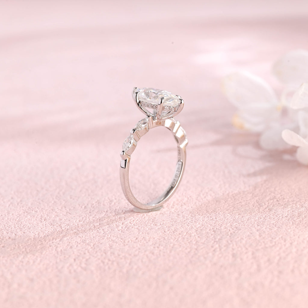 Side profile view of a marquise cut lab created diamond ring showing the hidden halo basket setting and 4 accent stones.