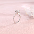 Side profile view of a marquise cut lab created diamond ring showing the hidden halo basket setting and 4 accent stones.