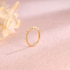 Side profile view of a cluster lab created diamond ring showing individual V-prongs and solid metal band.