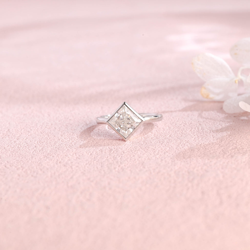 A minimalist 14k yellow gold princess cut lab grown diamond engagement ring featuring a sleek full bezel setting with a d color vs1 center stone.