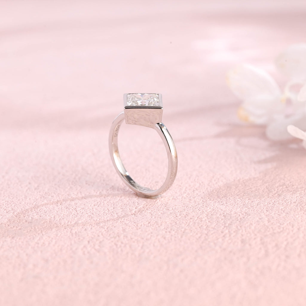 A minimalist 14k yellow gold princess cut lab grown diamond engagement ring featuring a sleek full bezel setting with a d color vs1 center stone.