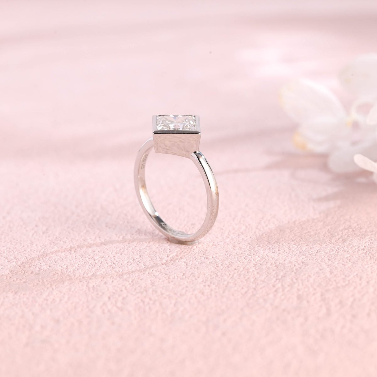 A minimalist 14k yellow gold princess cut lab grown diamond engagement ring featuring a sleek full bezel setting with a d color vs1 center stone.