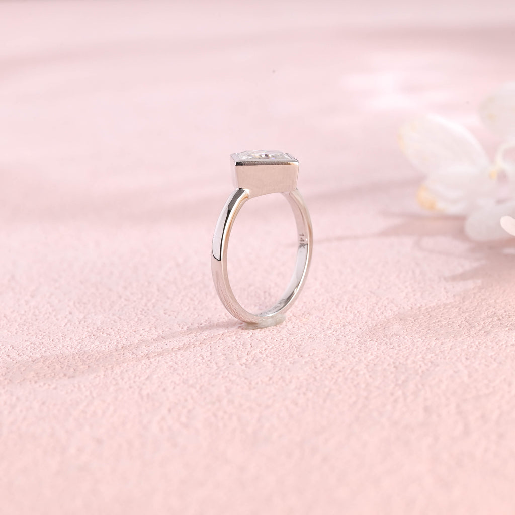 Side profile view of a modern princess cut lab created diamond full bezel setting showing the low-profile solid metal band design