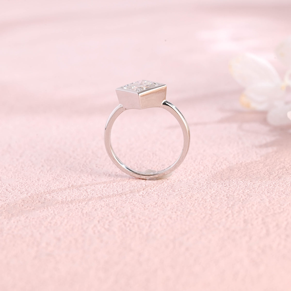 A minimalist 14k yellow gold princess cut lab grown diamond engagement ring featuring a sleek full bezel setting with a d color vs1 center stone.