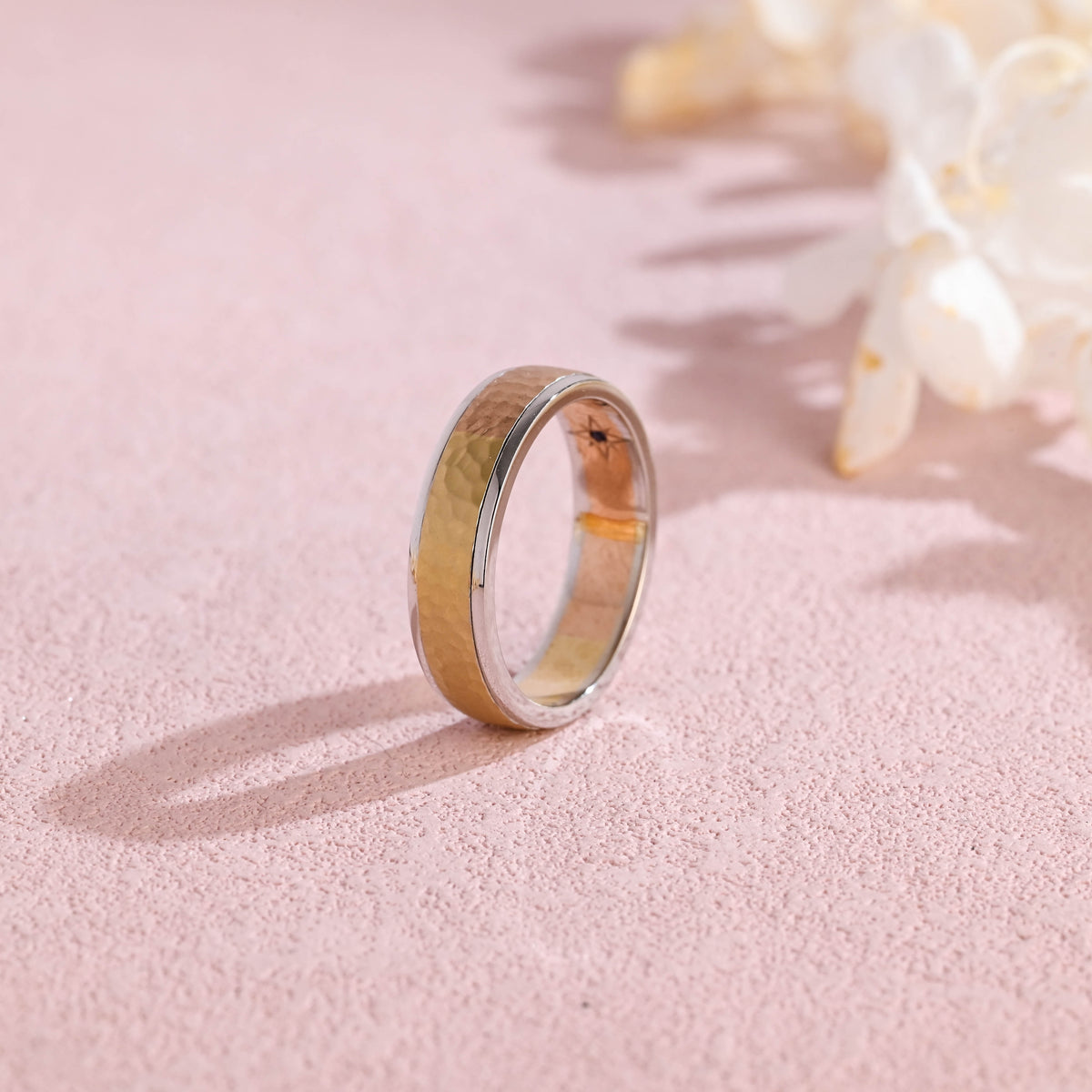 A stylish unisex two-tone modern band ring featuring a contrasting yellow and white gold finish on a neutral studio background.